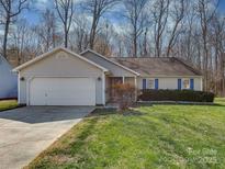 Charming single-story home with a well-maintained lawn, two-car garage, and inviting curb appeal at 8527 Conner Ridge Ln, Charlotte, NC 28269