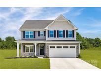 Charming two-story home with a two-car garage, landscaped yard, and inviting front porch at 1240 Cottage Green Dr # 0132, Monroe, NC 28112