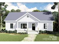 Charming home with a metal roof, inviting front porch, and well-maintained landscaping at 1475 32Nd Sw St, Hickory, NC 28602