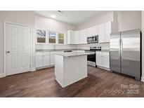 Modern kitchen featuring stainless steel appliances, an island, and ample cabinet space at 167 Saluda St, Chester, SC 29706