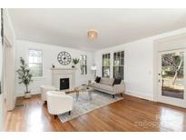 Bright living room boasts hardwood floors, fireplace, and neutral decor at 211 W 6Th Ave, Gastonia, NC 28052