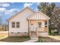 Charming exterior of home with light siding, covered porch, and well-maintained walkway at 213 Shannonhouse W St, Shelby, NC 28152
