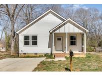Charming home with white siding, covered entry, and a well-manicured lawn at 220 Shannonhouse W St, Shelby, NC 28152