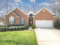 Charming brick home with a well-manicured lawn, two-car garage, and inviting curb appeal at 2713 Firethorn Ct # 48, Gastonia, NC 28056