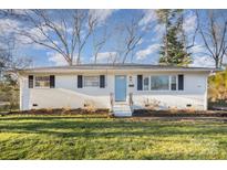 Charming single-story home with a manicured lawn and light blue front door at 4136 Woodgreen Ter, Charlotte, NC 28205