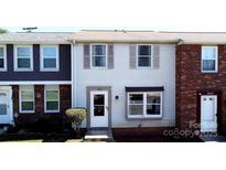 Charming two-story townhouse featuring neutral siding, complemented by well-placed windows and a welcoming front entrance at 7633 Holly Grove Ct, Charlotte, NC 28227