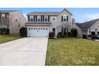 Charming two-story home with a manicured lawn and two-car garage at 1432 Astoria Nw Ln, Concord, NC 28027