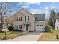 Charming two-story home with tan siding, green shutters, and a one-car garage at 166 Chere Helen Dr, Mooresville, NC 28115