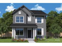 Charming two-story home featuring a symmetrical facade, gray siding, black roof, and bright white window trim at 17018 Malone Ln, Mint Hill, NC 28227