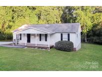 Charming single-story home featuring a covered front porch and well-maintained lawn at 19 Church St, York, SC 29745