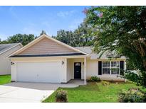 Charming single-story home with well-maintained lawn, attached garage, and inviting front entrance at 221 Chicago Ln, York, SC 29745