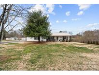 Charming single-story home with a metal roof and a covered front porch at 24253 Old Aquadale Rd, Albemarle, NC 28001