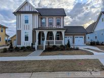 Charming two-story home with a welcoming front porch and well-manicured lawn in a cozy community at 287 Luray Way # 450, Rock Hill, SC 29730