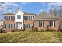 Two-story brick home with a manicured lawn and mature trees at 4421 3Rd Nw St, Hickory, NC 28601