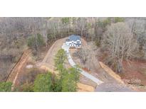 Stunning aerial view of a two-story home with a long driveway surrounded by trees at 558 Edmunds Ln # 41, Clover, SC 29710