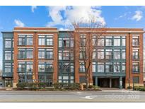 Attractive brick building with multiple floors, showcasing parking and a 'Pet Spa' business on the ground level at 626 N Graham St # 211, Charlotte, NC 28202