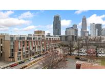 Brick apartment building with city skyline views on a sunny day at 710 W Trade St # 309, Charlotte, NC 28202