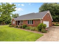 Charming brick home featuring a well-maintained lawn and classic architectural details at 105 Baymount Dr, Statesville, NC 28625
