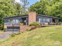 Charming two-story home with a brick chimney, gray paint and a well-manicured lawn at 109 Joe Teague Rd, Hickory, NC 28601