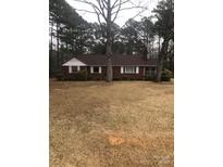 Charming brick ranch-style home with a well-maintained yard and mature trees at 1575 Us Hwy 220 Alt Hwy, Biscoe, NC 27341