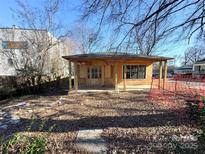 Exterior elevation of a small house under construction, featuring a covered porch and visible framework at 1600 Julia Maulden Pl, Charlotte, NC 28206