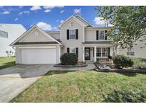 Charming two-story home with a well-manicured lawn, attached garage, and inviting front porch with black shutters at 257 Notable Ln, Rock Hill, SC 29732