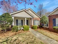 Charming single-story home with manicured lawn, complemented by flowering trees and inviting front porch at 2924 Zion Renaissance Ln, Charlotte, NC 28269