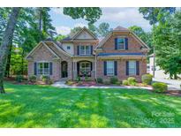 Beautiful two-story brick home featuring a well-manicured lawn and a welcoming front porch at 303 Ridge Reserve Dr # 29, Clover, SC 29710