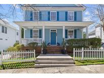 Charming two-story home featuring a welcoming front porch with white columns and a well-manicured lawn and picket fence at 3208 Fifth Baxter Xing, Fort Mill, SC 29708