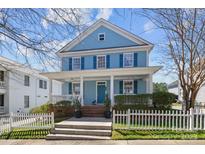 Charming two-story home with a welcoming front porch and a well-manicured lawn at 3208 Fifth Baxter Xing, Fort Mill, SC 29708