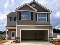 Two-story home featuring neutral siding, black shutters, and an attached two-car garage in a suburban community at 3362 Burberry Dr, Gastonia, NC 28052
