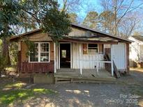 Dilapidated exterior of a fixer-upper home, awaiting renovation and new life at 349 N Kendall N St, Norwood, NC 28128
