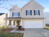 Charming two-story home with a two-car garage and a welcoming front porch at 4219 Robinwood Dr, Charlotte, NC 28212