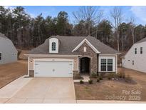 Inviting single-Gathering home showcases stone detailing, a two-car garage, and well-maintained landscaping at 4720 Maiden Creek Way, Maiden, NC 28650