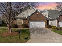 Charming brick home featuring a well-manicured lawn and a convenient two-car garage at 620 Amethyst Cir, Fort Mill, SC 29708