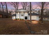 Inviting two-story home with a crisp white facade, front door, and stone walkway at 805 East St, Albemarle, NC 28001