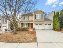 Charming two-story home with a two-car garage, red door, and manicured landscaping at 114 Sheridan Ct, Mooresville, NC 28115