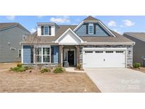 Charming two-story home featuring a two-car garage, well-maintained lawn, and inviting curb appeal at 13012 Canterbury Castle Dr, Charlotte, NC 28273