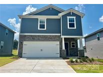 Charming two-story home features a stone facade, white garage door, and manicured landscaping at 1421 31St Ne St, Conover, NC 28613
