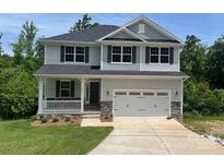 Charming two-story home featuring a covered front porch, two-car garage, and landscaped front yard at 149 High Rock Ct # 02, Statesville, NC 28677