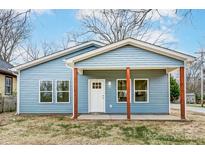 Charming blue house with a covered front porch, offering a welcoming entrance and curb appeal at 2313 N Main St, Kannapolis, NC 28081