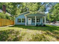 Charming blue home with a welcoming front porch and black shutters at 2313 N Main St, Kannapolis, NC 28081