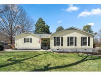 Charming single-story home with a well-manicured lawn and classic black shutters at 2413 Hoffman St, Gastonia, NC 28054