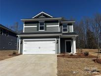 Charming two-story home featuring a two-car garage, stylish siding, and a well-maintained front yard at 311 Alden Ct, Shelby, NC 28152