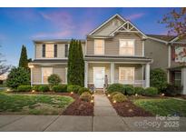 Charming two-story home featuring landscaped yard and a welcoming front porch at twilight at 3350 Keady Mill Loop, Kannapolis, NC 28081