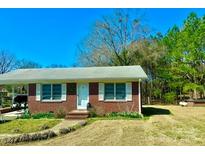 Charming one-story home featuring a well-maintained lawn and a convenient carport at 3444 Country Club Rd, Wadesboro, NC 28170