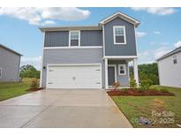 Charming two-story home featuring a two-car garage and a beautifully landscaped front yard at 410 Luna Ln, Shelby, NC 28152