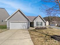 Charming single-story home featuring gray siding, a well-maintained lawn, and an attached one-car garage at 4906 Lynn Lee Cir, Charlotte, NC 28269