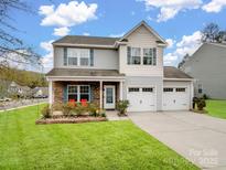 Charming two-story home with a well-manicured lawn and a two-car garage, perfect for Gathering living at 629 Gants Rd, York, SC 29745