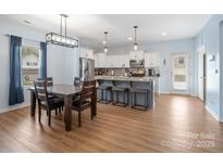 Bright kitchen with white cabinets, stainless steel appliances, and an island with barstool seating at 629 Gants Rd, York, SC 29745